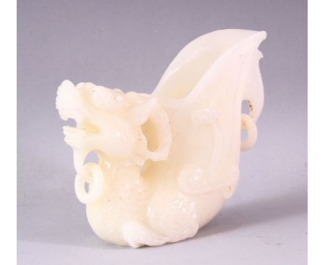 A 20TH CENTURY CHINESE CARVED WHITE JADE LIBATION CUP OF A LION DOG, 14cm high.