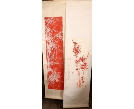 TWO CHINESE RED INK SCROLL PICTURES, both depicting bamboo, both with a calligraphic script, images sizes 89cm x 37cm and 130