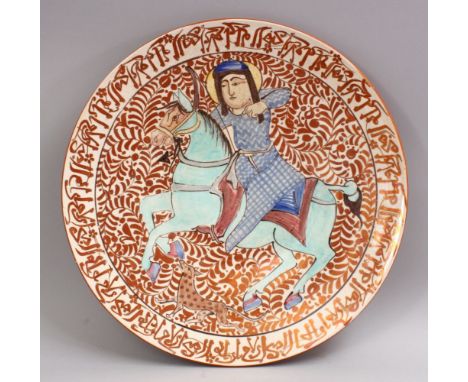 A GOOD 19TH CENTURY ISLAMIC PERSIAN POTTERY PLATE, decorated with a border of calligraphy around a king upon horseback (rim A