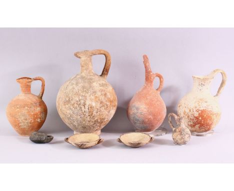 A SMALL COLLECTION OF EXCAVATED POTTERY ITEMS, comprising four teracotta jugs, two small twin handle dishes and an oil lamp, 