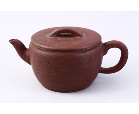 A CHINESE YIXING CLAY CALLIGRAPHY TEA POT, the body of the pot with carved calligraphy, also to the lid, the base with an imp