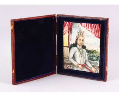 A 19TH CENTURY INDIAN PORTRAIT MINIATURE OF A SEATED GENTLEMAN, painted on ivory in a leather folding travelling case, miniat