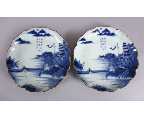 A PAIR OF JAPANESE MEIJI PERIOD BLUE &amp; WHITE ARITA PORCELAIN DISHES, each decorated with native waterside landscape scene