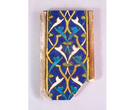 A 15TH CENTURY PERSIAN OR CENTRAL ASIAN TIMURID CUERDA SECA TILE, the tile with stylized motif decoration, the verso with a C
