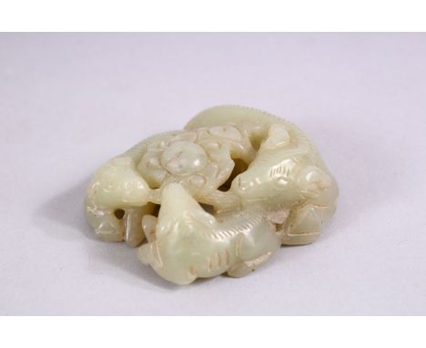 A SMALL CHINESE CARVED JADE GROUP of three rams, in a fitted box.