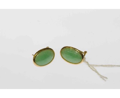 Pair of jadeite earrings, the oval cut jadeite plaques set within a simple surround on post and clip fittings, stamped 18K, t