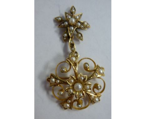 A 15ct gold wire framed and seed pearl set circular brooch with a star pendant