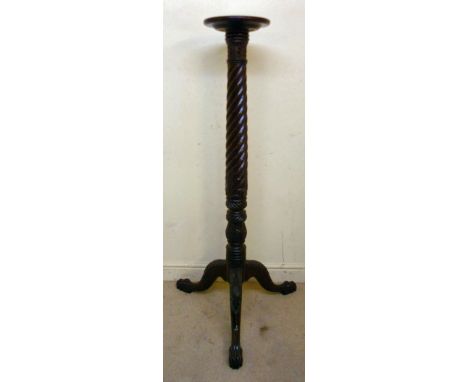 A 1920s mahogany torchere, having a dished top, over a wrythen and acanthus carved column, raised on a splayed tripod base wi