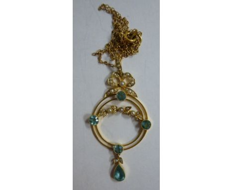 A 15ct gold wire framed, aqua and seed pearl set circular, ribbon tied brooch with a peardrop pendant, on a fine neckchain