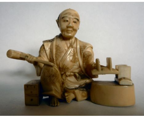 An early 20thC Japanese carved ivory figure, a shoemaker at work  2.5''h