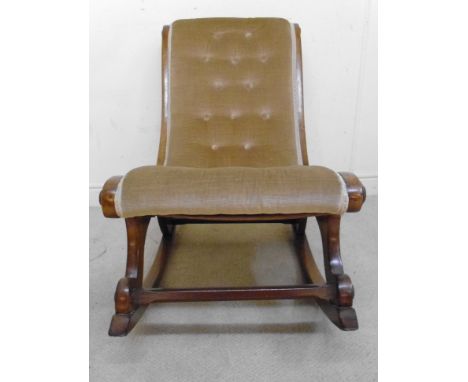 A late Victorian mahogany showwood framed rocking chair, the one-piece, boat shaped seat and back with scrolled ends, button 