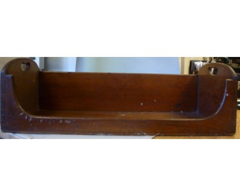 An early 20thC mahogany book trough, having straight sides, arched ends, a low front and cut-out carrying handles  24''w