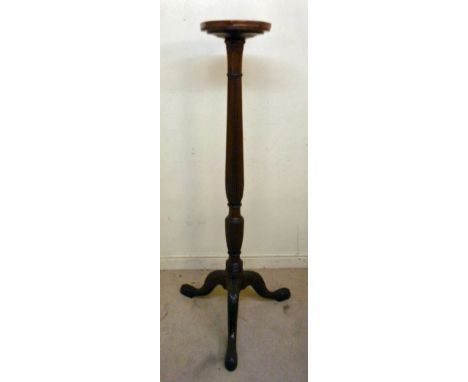 A 1920s and later mahogany torchere, having a dished top and acanthus carved, reeded, baluster column, raised on a splayed tr