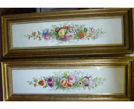 A pair of late Victorian ivory glazed and gilt bordered china wall plaques, decorated with English country garden flowers  36