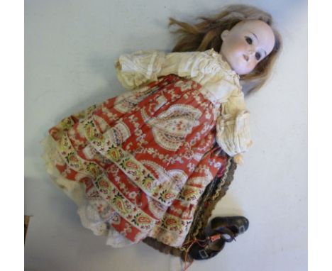 An early 20thC Armand Marseille bisque head doll, having painted features and weighted, sleeping eyes, impressed 390.A.2/OXM,
