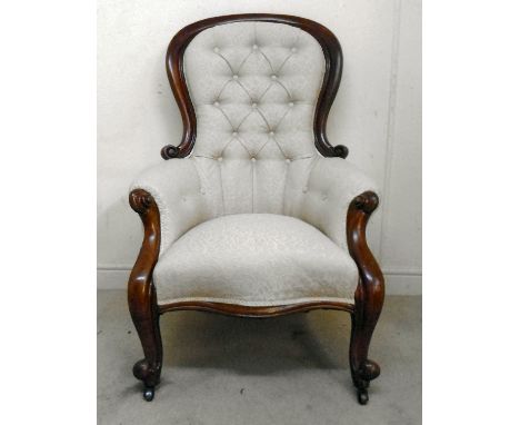 A late Victorian mahogany moulded and scrolled, showwood framed spoonback chair with enclosed arms, part button upholstered i