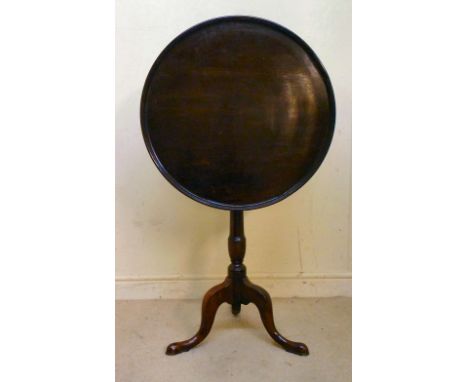 An early 19thC mahogany tip-top pedestal table, having a turned, raised border over a tapered vase shaped column  28''h  24''