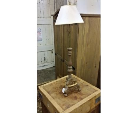 A small floor standing lamp with timber base and brass top extendable.