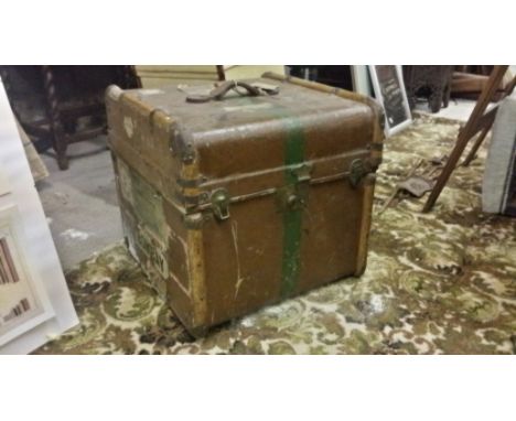 A square cain cruiser trunk with travel labels.