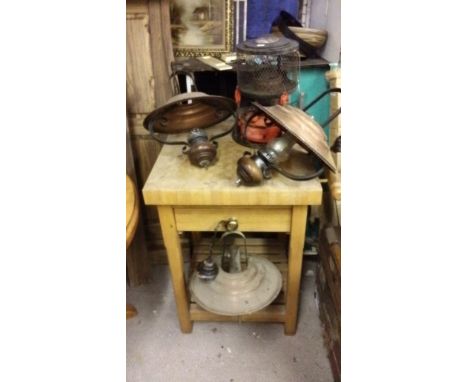 Three copper light fittings and a paraffin lamp