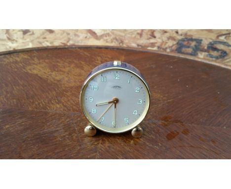 A Looping seven jewel brass and enamel alarm clock fully working.