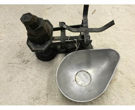 A set of kitchen weighing scales with weights.