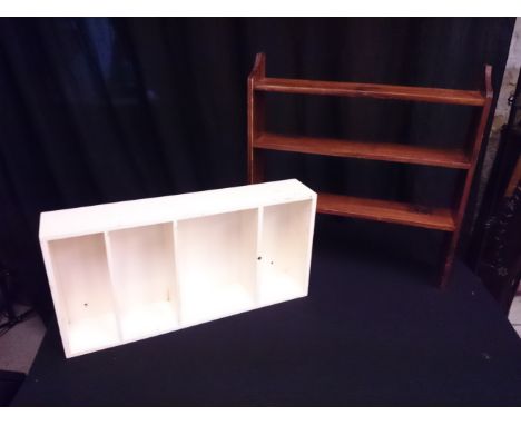 A white painted boxed small shelving unit and an open backed shelf unit.