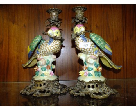 A PAIR OF MODERN CERAMIC AND METAL PARROT CANDLE STICK HOLDERS