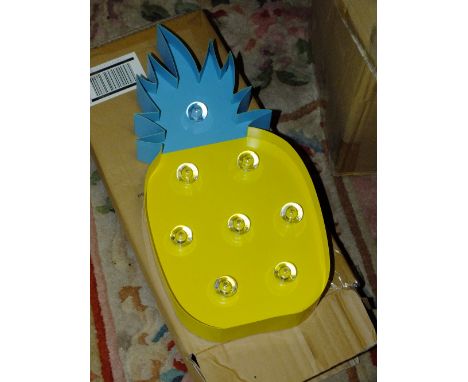 FOUR BOXES OF LIGHT UP PINEAPPLES