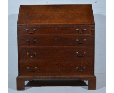 George III oak bureau, fall-front enclosing an interior fitted with a cupboard, pigeon-holes and drawers, above four long gra