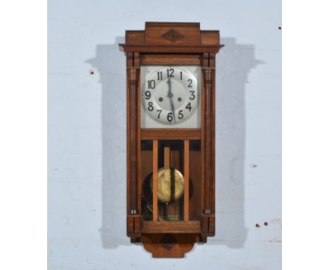 Wall clock, walnut case of architectural design, glazed door, silvered dial, approximately 72cm.