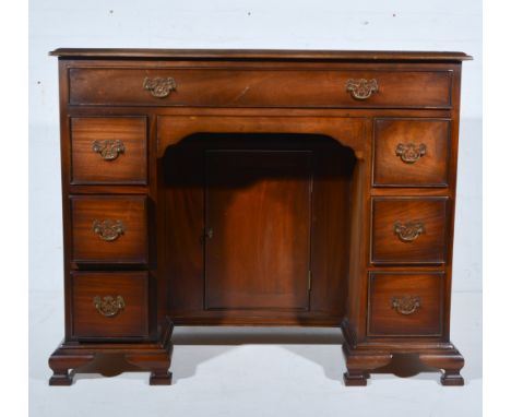 Georgian style mahogany kneehole desk, one long drawer above three drawers to each side of the kneehole, with cupboard in the