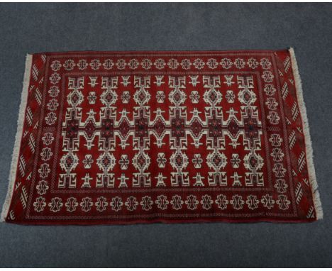Kilim / Persian rug, with three rows of six guls joined by poles, against a crimson ground, enclosed by borders, 150 x 108cm