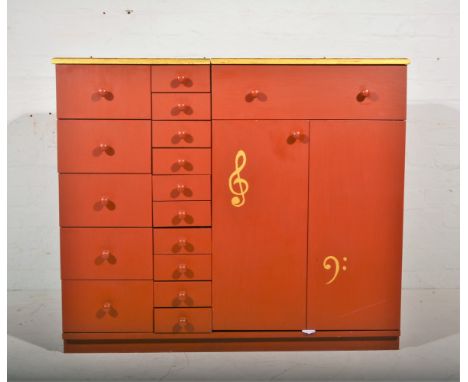 A custom built painted music cabinet, with hinged compartment to house turntable above a cupboard for amplifier, flanked by t