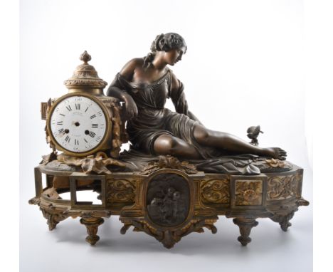 French ormolu brass mantel clock, reclining figure by a bird's nest, circular enamel dial with Roman numerals, signed Deniere