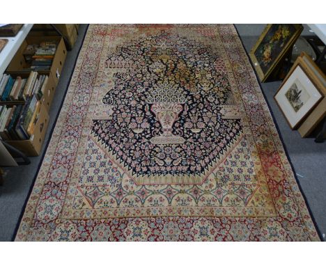 Kirman Persian pattern rug, with a formal decoration on an urn, flowers, with spandrels and formal border, 303cm x 186cm, dam