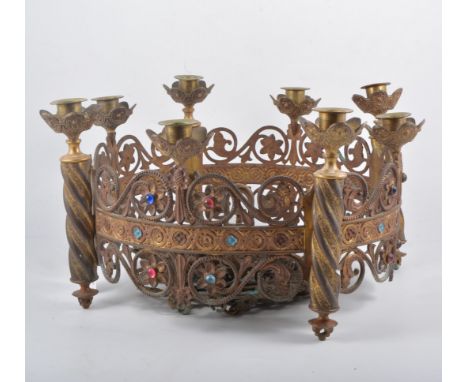 A gilt metal continental centre light fitting, coronet form with eight candle sconces on turned column supports, scolling flo