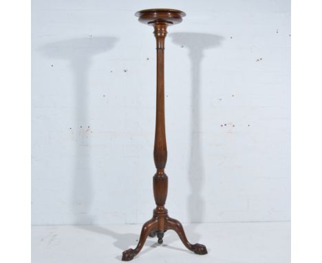 Mahogany torchere with a circular top, octagonal baluster column, tripod legs, ball and claw feet, 145cm.