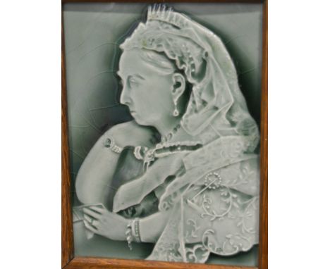 A Victorian pottery portrait relief tile, depicting Queen Victoria in mourning, under celadon glaze, 8inch x 6inch in oak fra