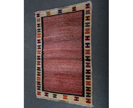 Gabbeh wool rug; with red speckled field, enclosed by cream borders,with H shaped design  152 x 109cm.