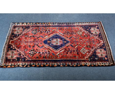 Gabbeh wool rug; central stepped medallion on a pol, against a red ground enclosed by similar spandrels, narrow borders, 202 