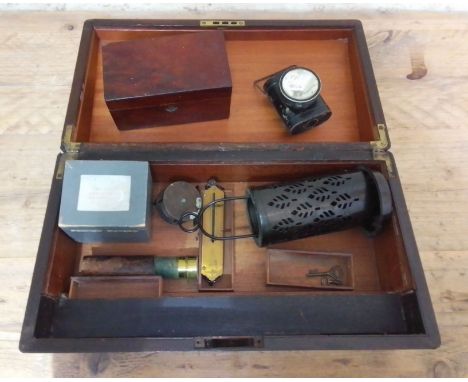 A rosewood writing slope with campaign inset handles (as found) containing various collectables; tea caddy, telescope, reel, 