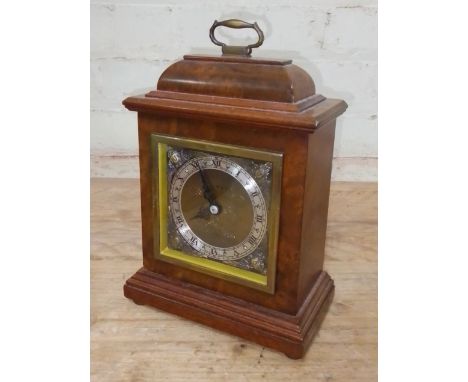 An Elliott burr walnut clock, retailer's Garrard.