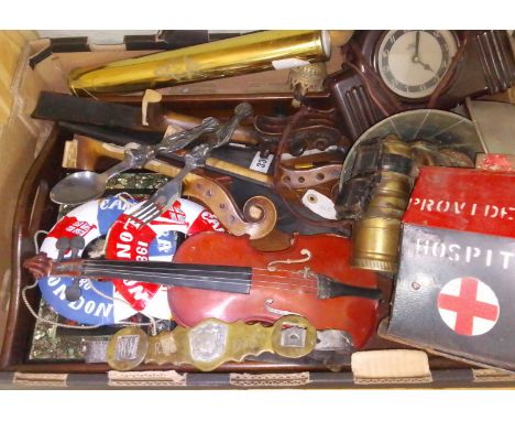 A box of assorted collectables including a charity box, violin parts, a kaleidoscope, female nude handled spoon and fork, bic
