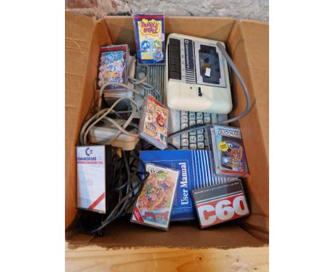 A Commadore 64 console, tape deck &amp; assorted games. 
