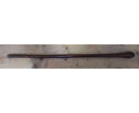 A wooden throwing stick, length 89cm. 