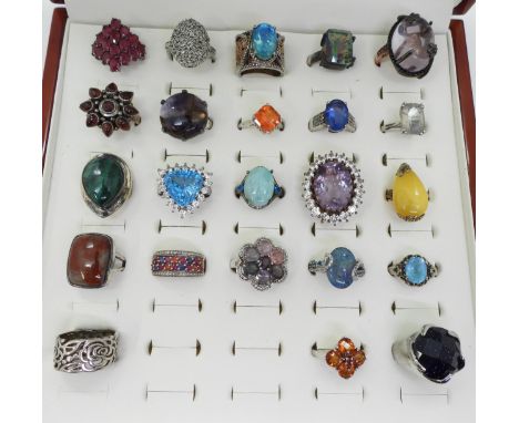 Twenty one silver gem set rings to include, a diamond cluster ring, mystic topaz, garnet, treated ruby and opal triplets, and