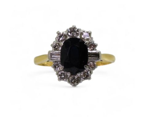 An 18ct and platinum sapphire and diamond cluster ring, set with estimated approx 0.40cts of brilliant and baguette diamonds,