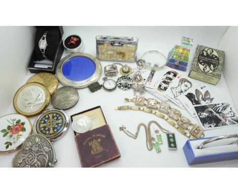 A collection of compacts to include a mother of pearl compact and pair of opera glasses, a continental silver example, a silv