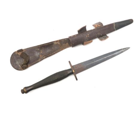 A Fairbairn-Sykes Second Pattern fighting knife/dagger, the hatched grip stamped with Broad Arrow, with metal-mounted leather